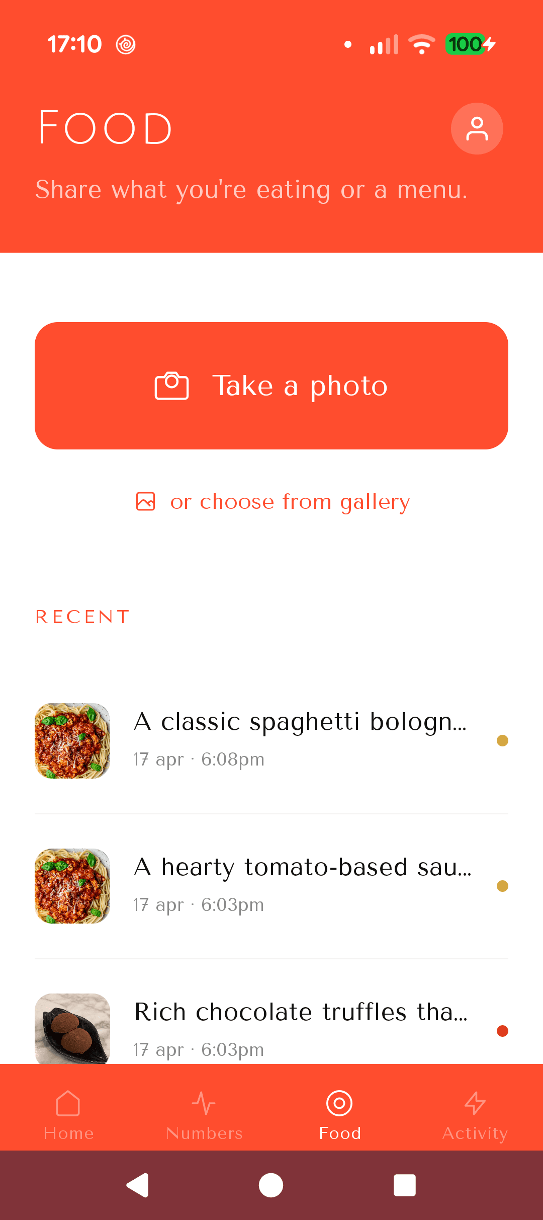 Food screen with a Take a photo button and a list of recent meals including spaghetti bolognese and tomato-based sauce.